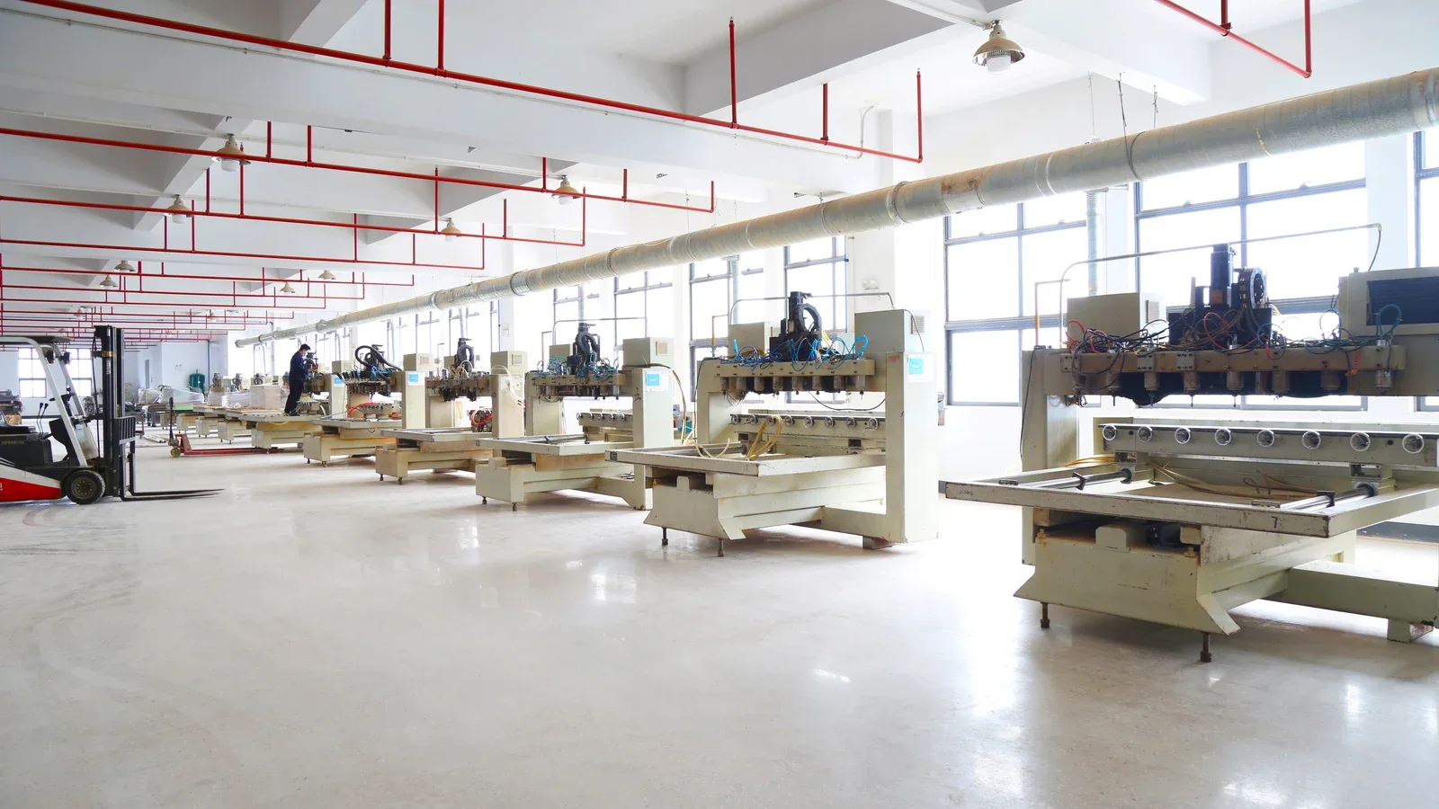 Woodworking machines arranged along a furniture production line