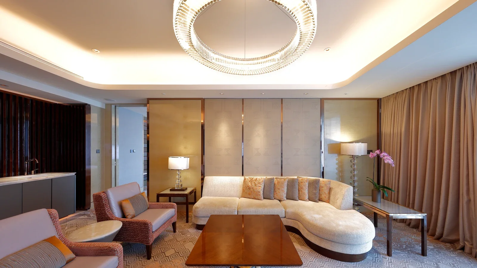 Hospitality suite with sofa, lounge chairs, tables and cabinetry