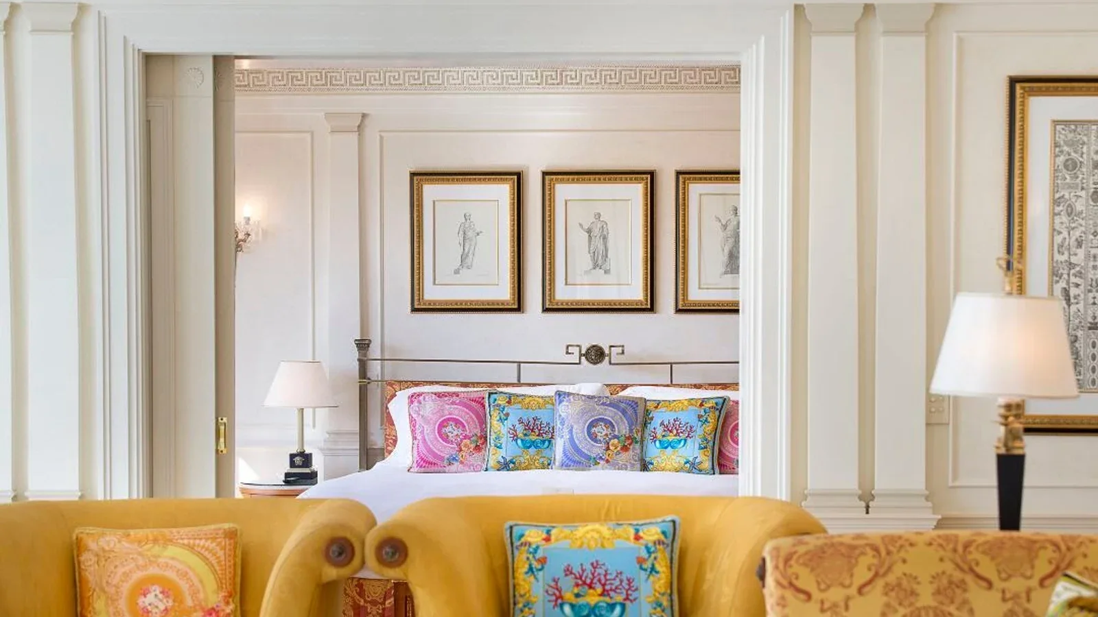 Hospitality room with bed, seating, tables, lighting and wall trim