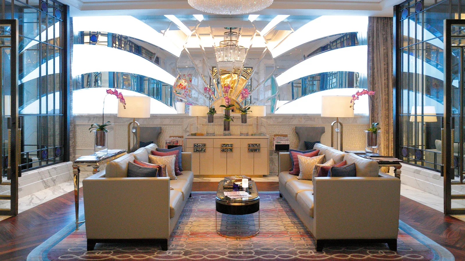 Hospitality lounge with sofas chairs tables and storage furniture