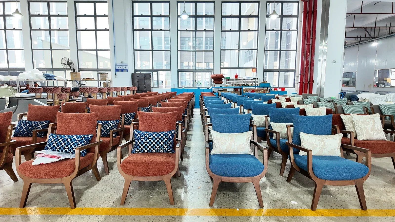 Rows of upholstered hotel chairs in a Gainwell production area