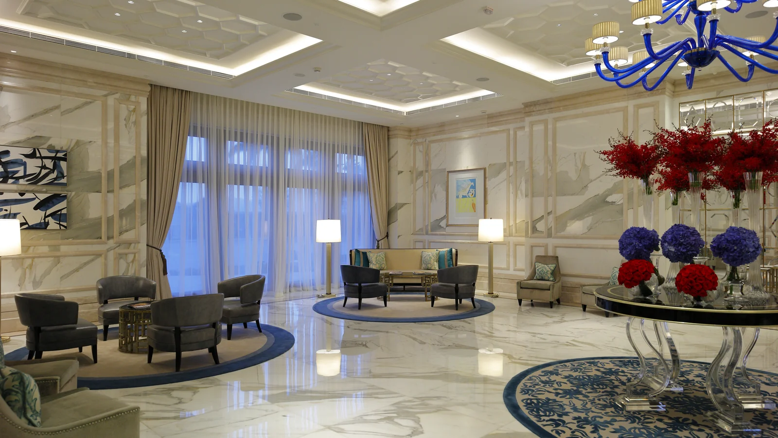 Hotel lobby with multiple seating zones and open circulation between furniture groups