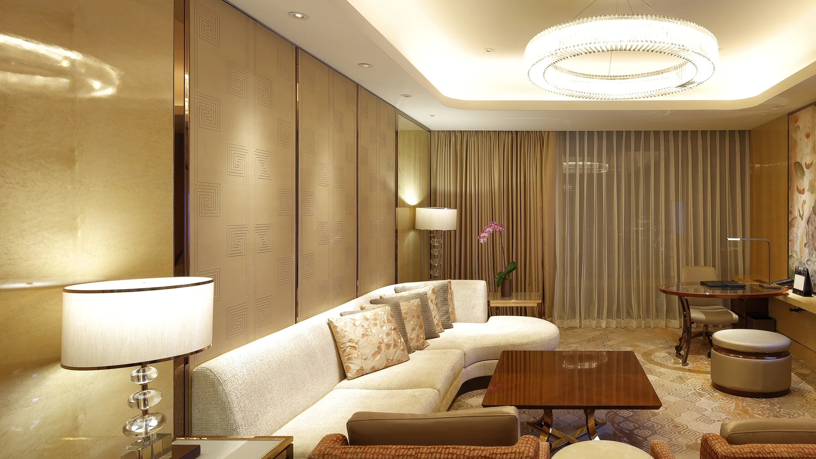 Hotel public area with sofas, lounge chairs, tables and wall panels