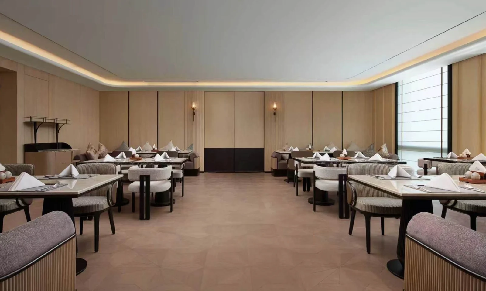 Rows of restaurant tables and chairs arranged around an open central route