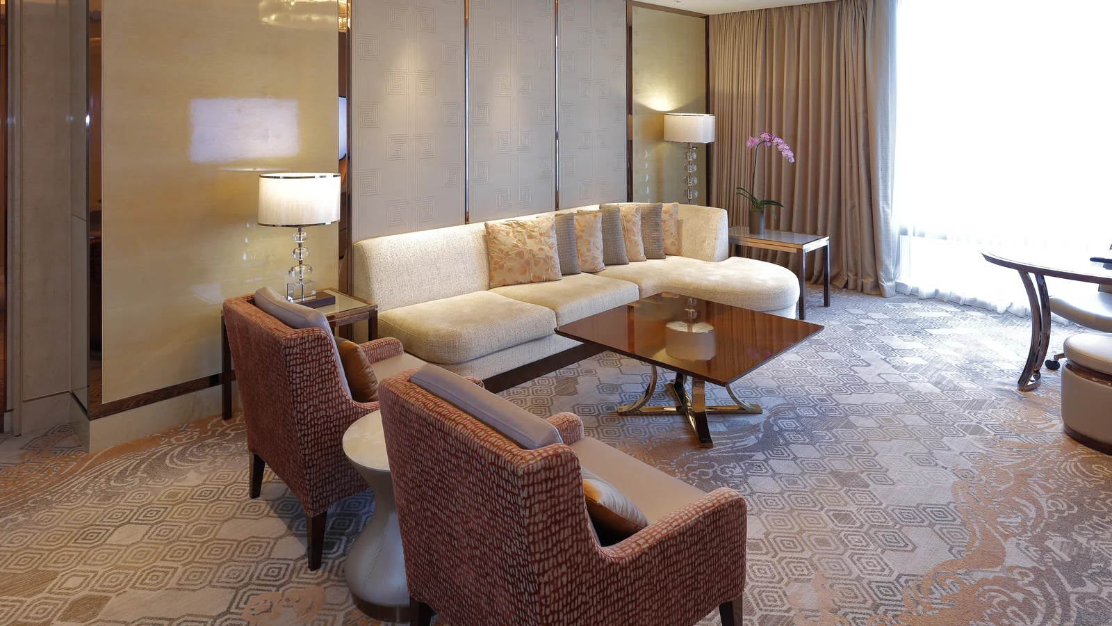 Mixed hotel lounge seating with sofa, chairs, coffee table and open approach