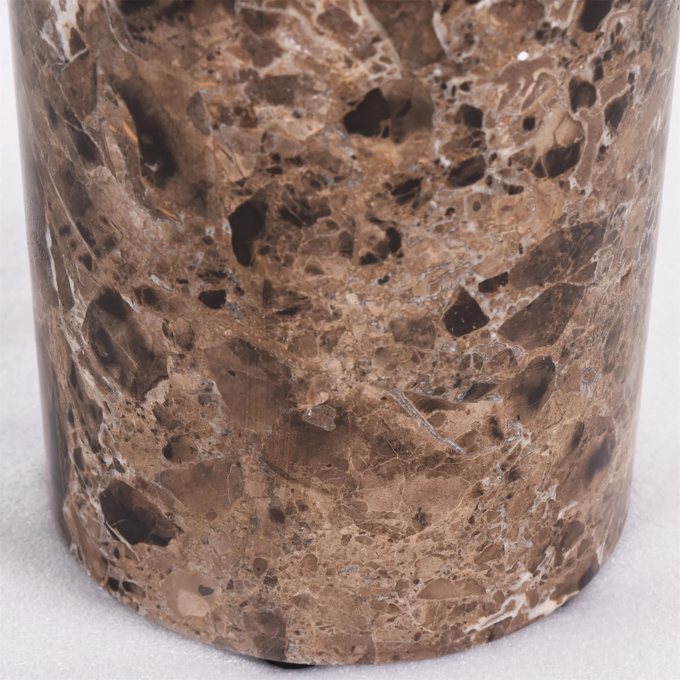 Polished brown stone-like cylindrical table base with visible pattern variation