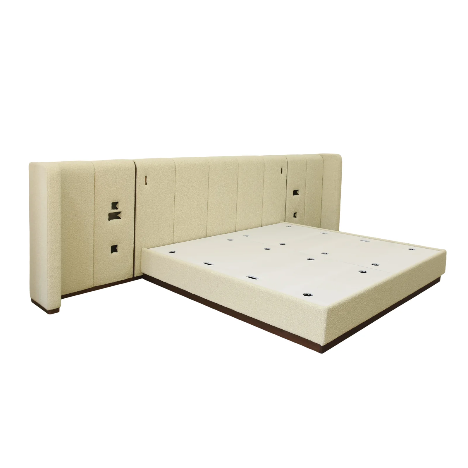 Cream hotel bed with an asymmetrical upholstered headboard wall