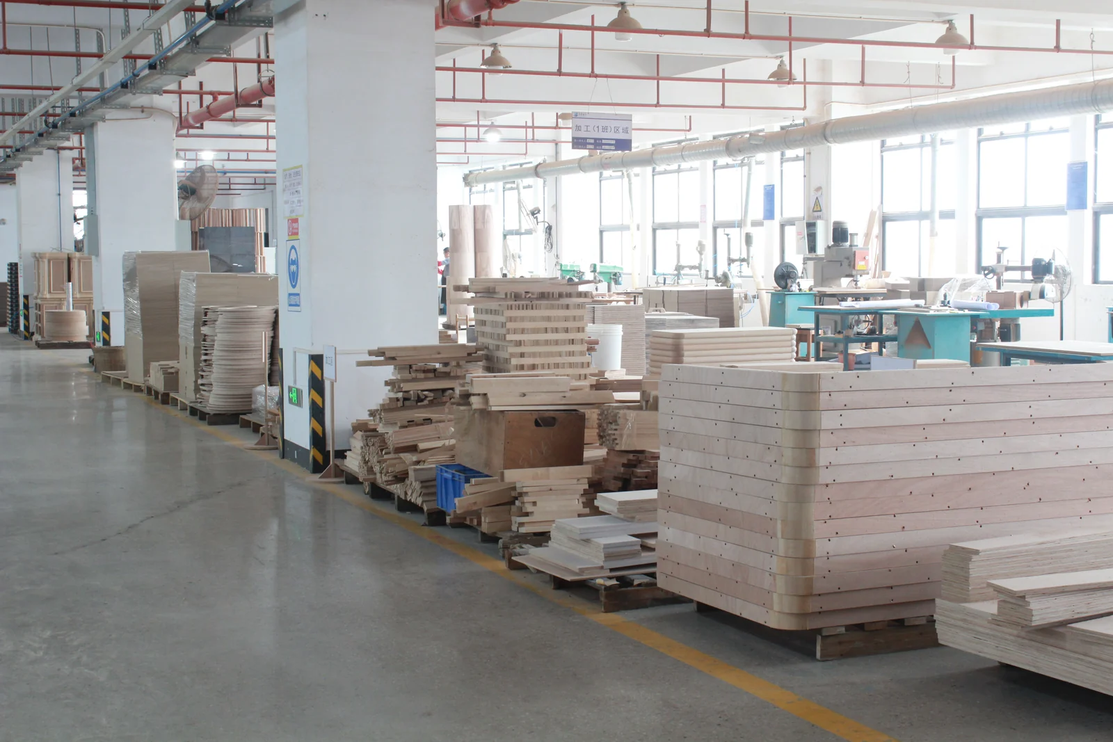 Coded hotel furniture components staged for production
