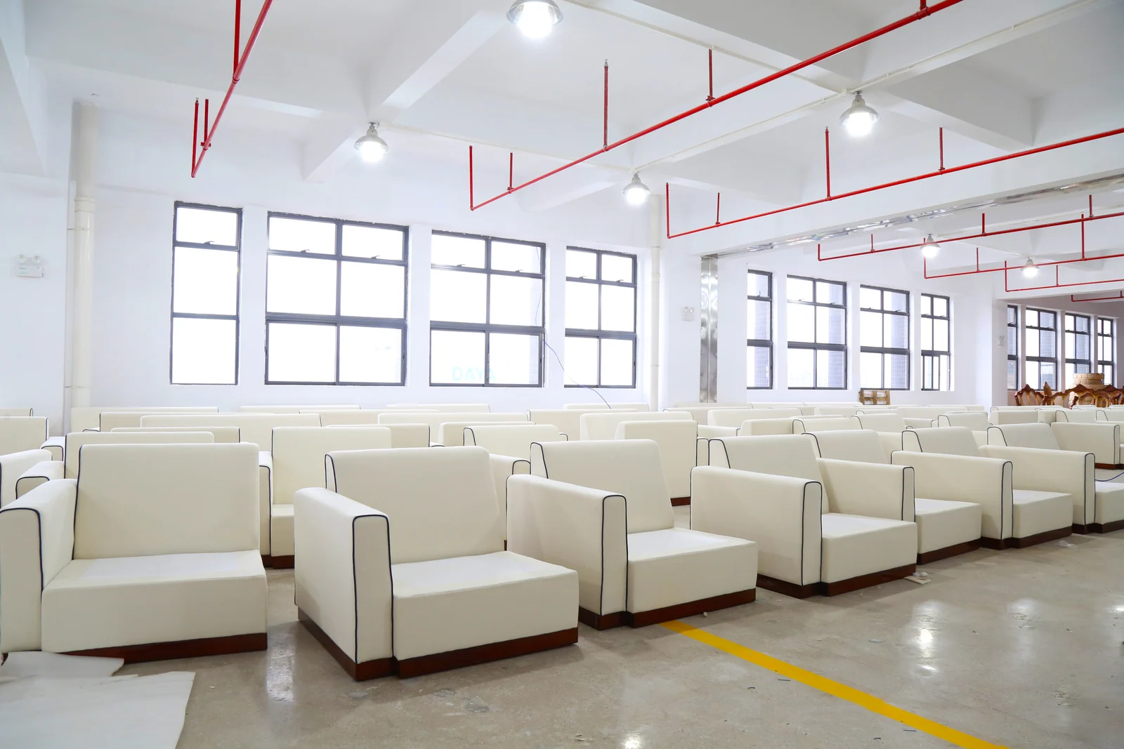Rows of completed upholstered chairs arranged for batch review