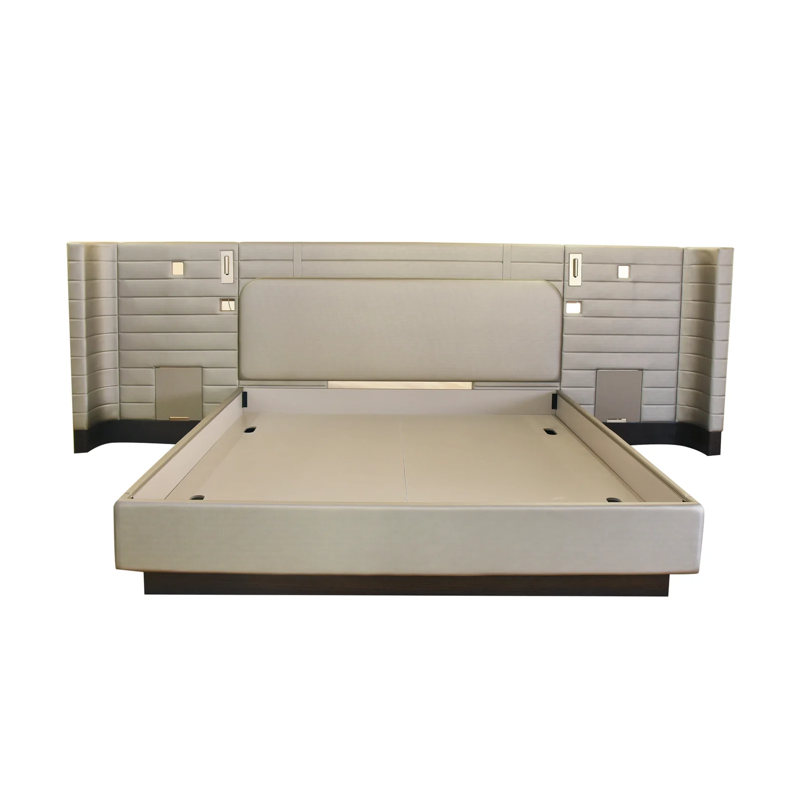 Hotel bed and upholstered headboard with integrated bedside service zones