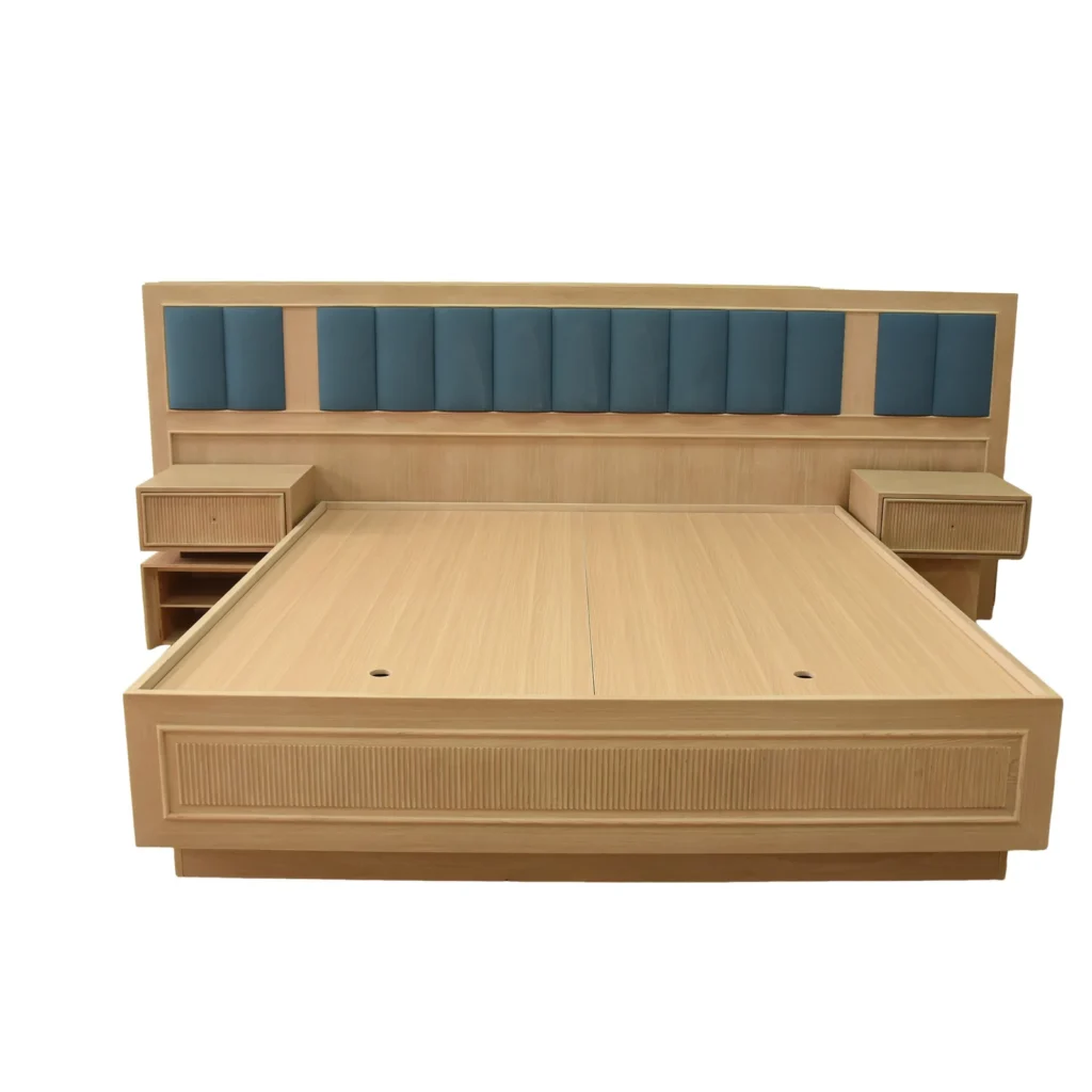 Hotel bed centered within a wide timber headboard wall and two nightstands