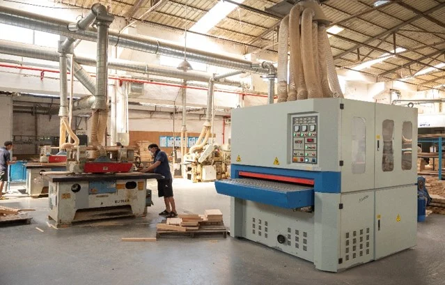 Wood sanding stations with extraction equipment in a furniture factory