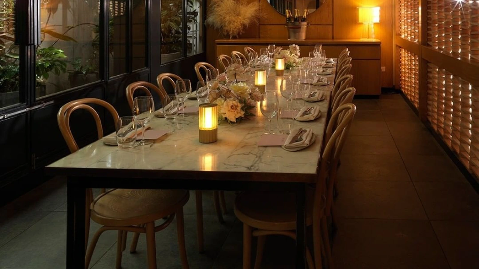 Long rectangular dining table with visible corner legs and an apron beside dining chairs.